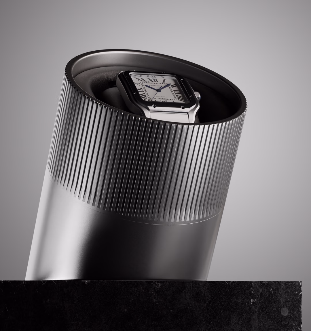 The ChronoArx winder on a black stone plinth, a Cartier Santos resting in its cradle.